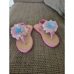 BEBE Girls pink sandals with multicolor flower on top of foot